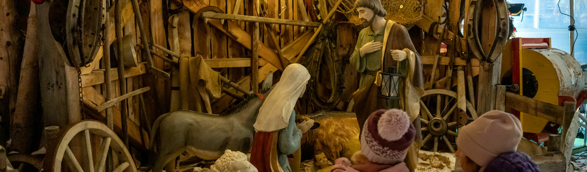 A family marvelling at the large nativity scene at the Achensee Museum Christmas in Maurach.