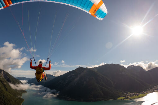 A paragliding adventure lets you enjoy incredible views of the lake and the mountains.