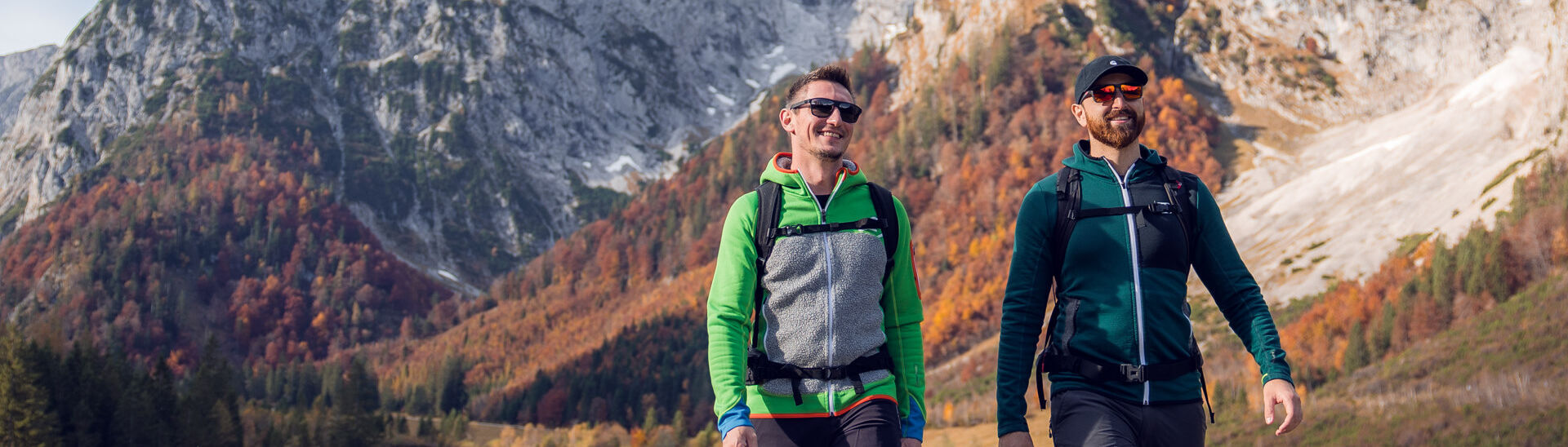 Autumn hike at Lake Achensee Two hikers take advantage of the beautiful weather and embark on an autumn hike through the colorful Falzthurn Valley in the Nature Park Karwendel. In the picture, the Sonnjoch stands out prominently.