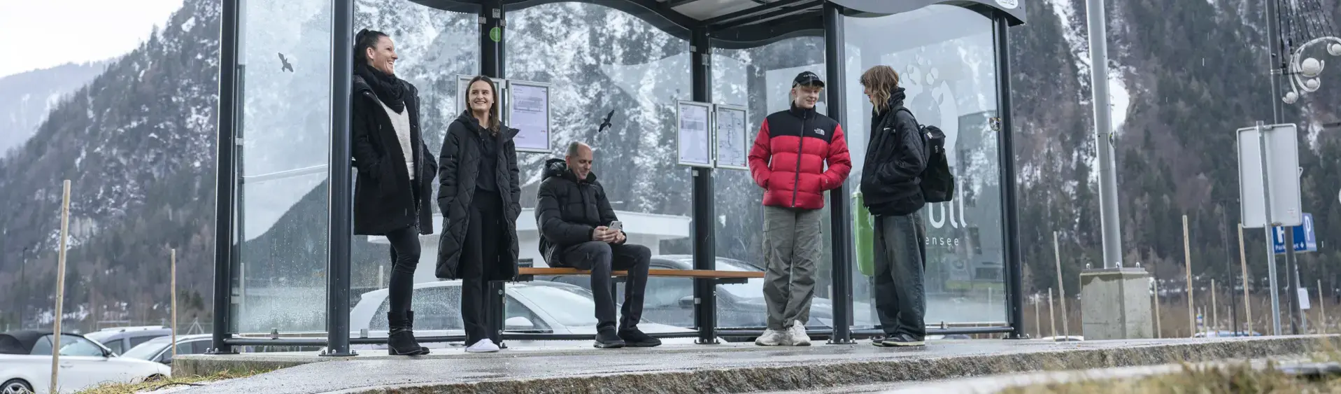 Bus stop Atoll Achensee A group of people waiting for the bus in the Achensee atoll in winter.