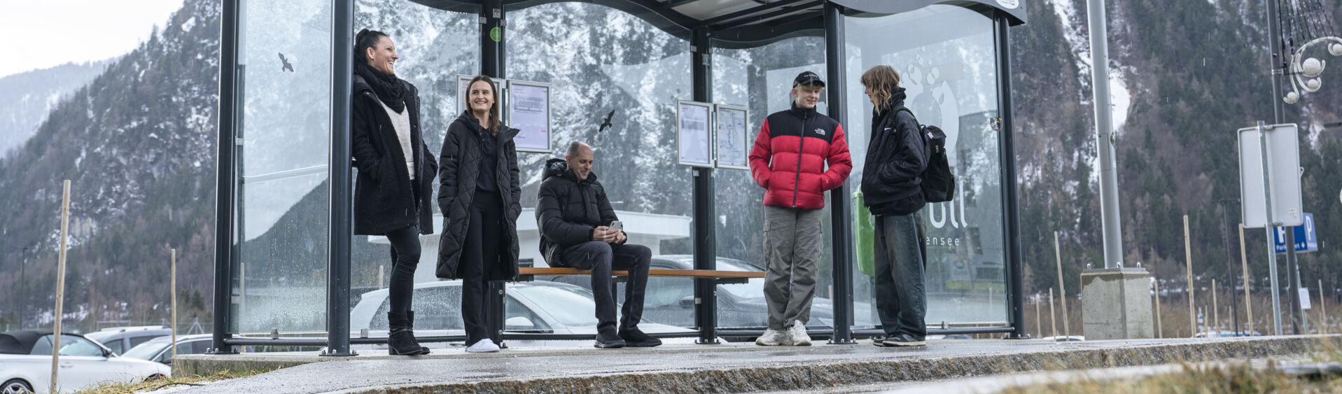 A group of people waiting for the bus in the Achensee atoll in winter.