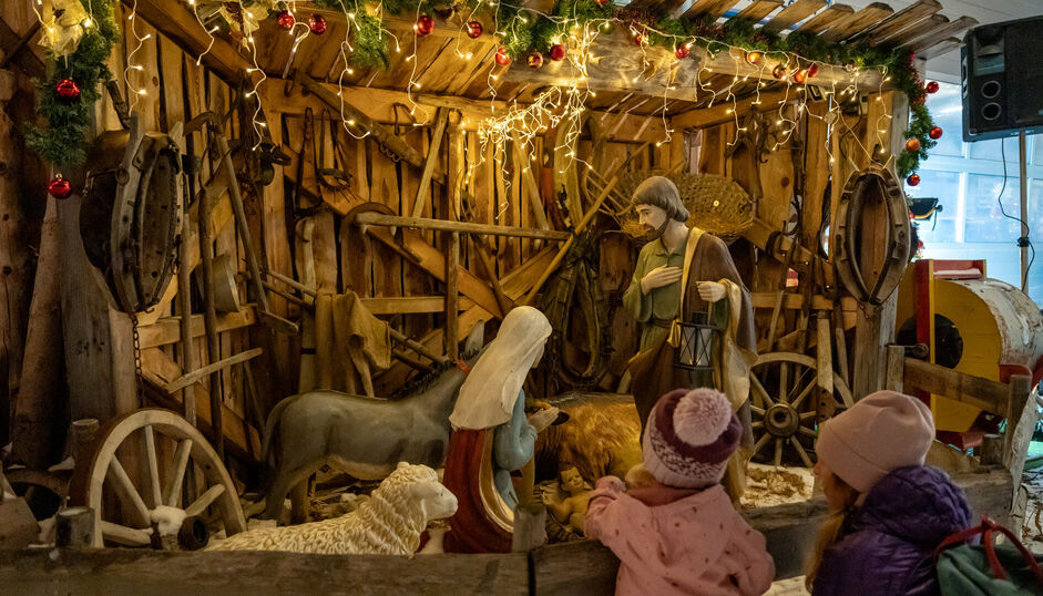 Traditional nativity scene A family marvelling at the large nativity scene at the Achensee Museum Christmas in Maurach.