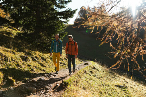 Two mountaineers are exploring the Rofan Mountains during the autumn season.