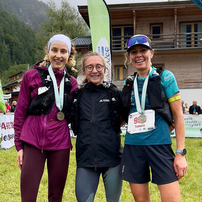 The three winners of the Karwendelmarsch 2025 smile contentedly for the camera.