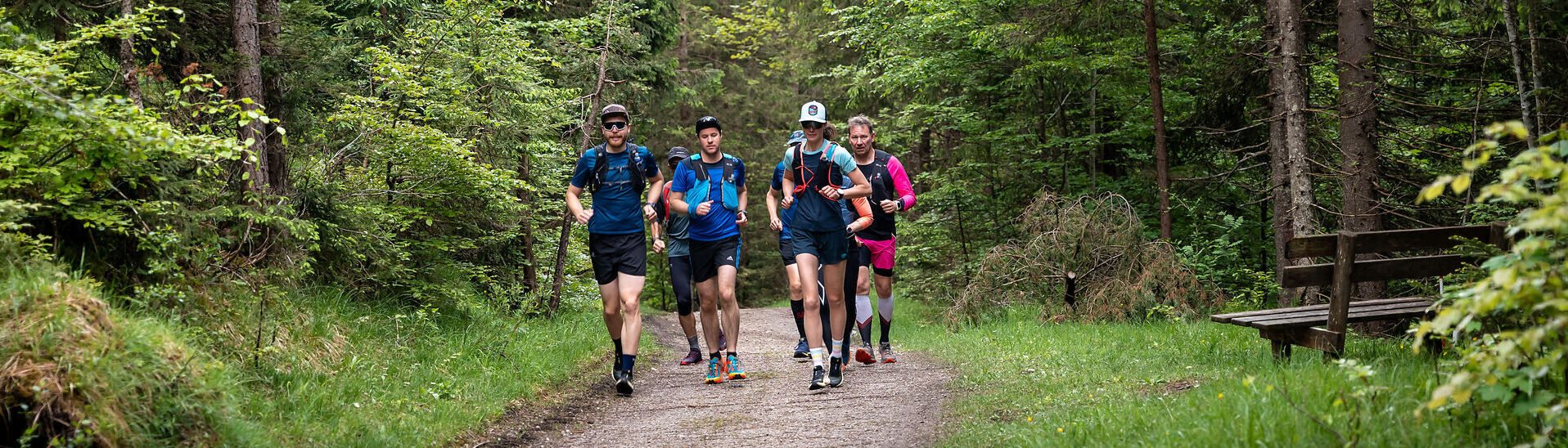 A group of runners out and about on gravel paths in the natural landscape of Lake Achensee.