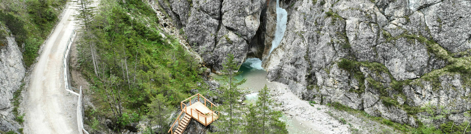 Kraftplatz Steinberg am Rofan Der Kraftplatz Steinberg am Rofan ist eine hölzerne Aussichtsplattform mit Sitzgelegenheit und Blick auf einen Wasserfall.