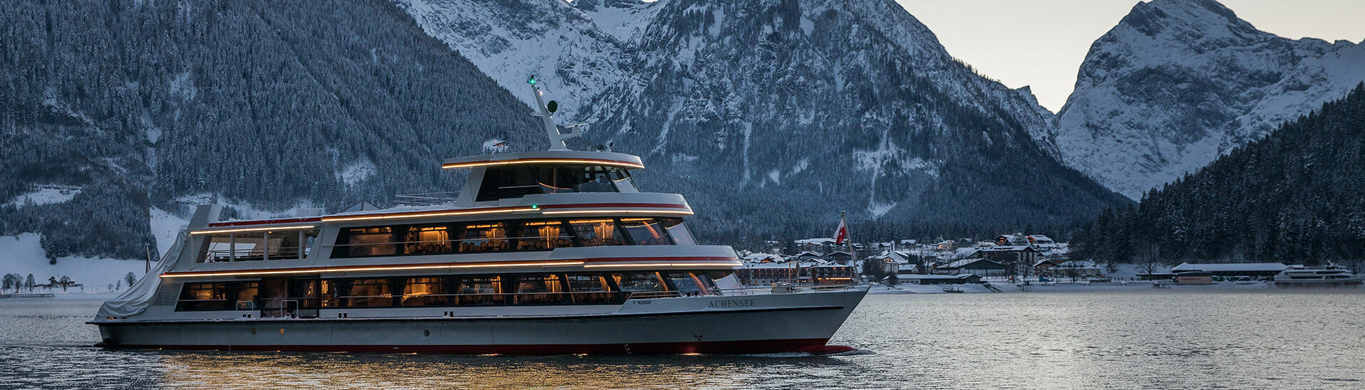Achenseeschifffahrt am Abend Die MS Achensee bei einer Rundfahrt an einem Winterabend auf dem Achensee. Im Hintergrund sieht man das Dorf Pertisau und das Karwendelgebirge.