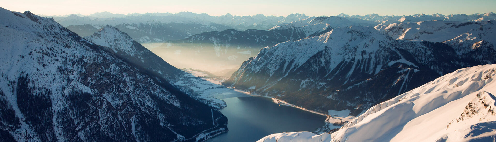 Blick auf den Achensee und die verschneiten Dörfer Maurach und Pertisau.
