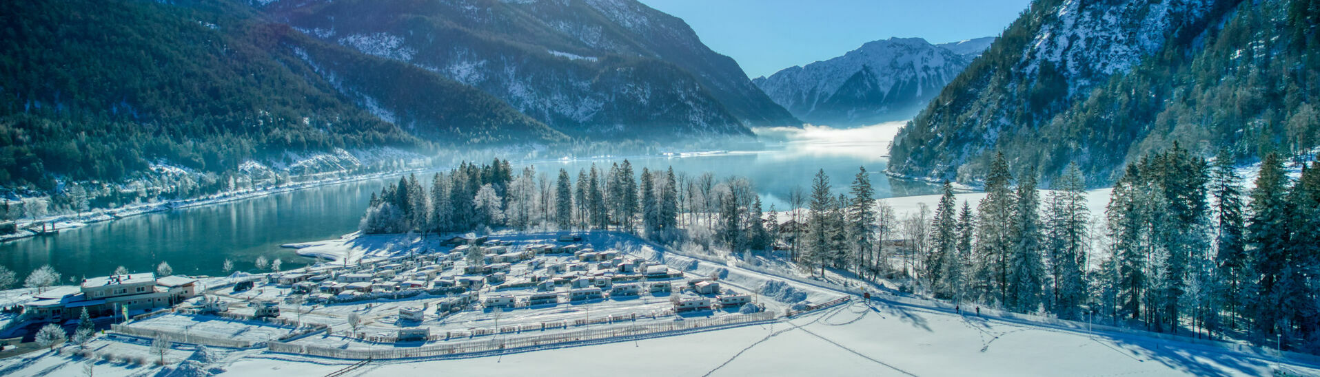 Cross-country ski trails in Achenkirch am Achensee backdropped by the Alpen Caravan Park Achensee and the lake.