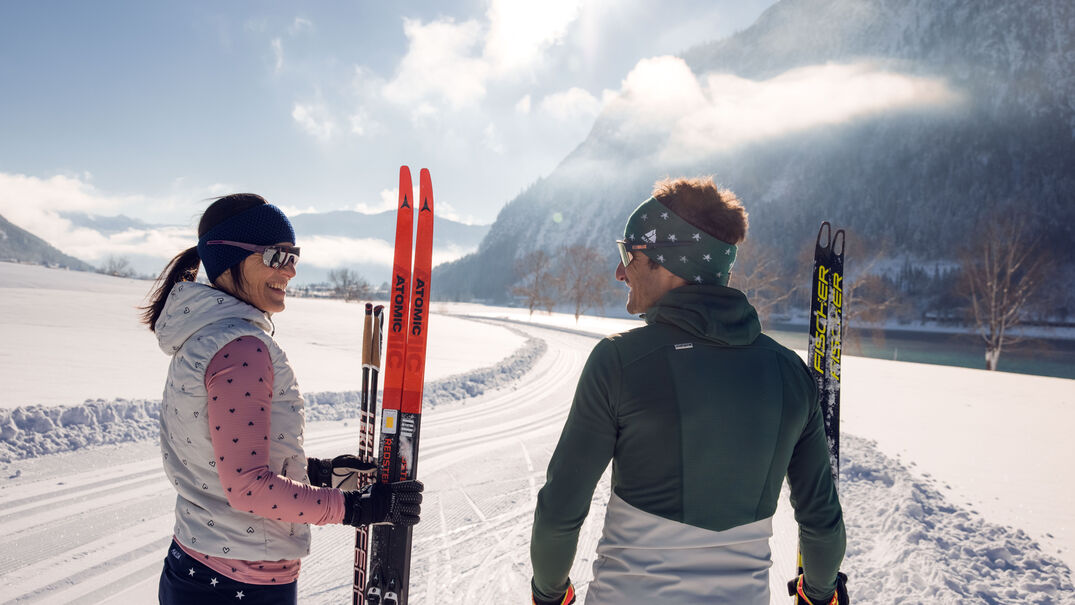 Cross-country skiing in Maurach am Achensee Cross-country skiing fun in Maurach at Achensee for a young couple.