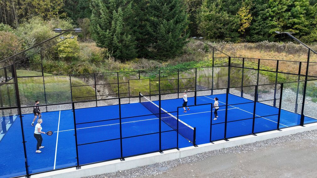 Padel is usually played in doubles, with four players on court.