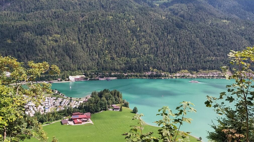 View of the northern shore of Lake Achensee in Achenkirch with the campsite and Scholastika along the MTB route to the Seekaralm.
