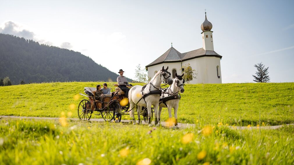 Horse-drawn carriage ride below the Annakircherl in Achenkirch