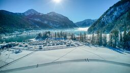 Cross-country ski lake trail Oberautal in Achenkirch - backdropped by the Alpen Caravan Park Achensee and the lake.